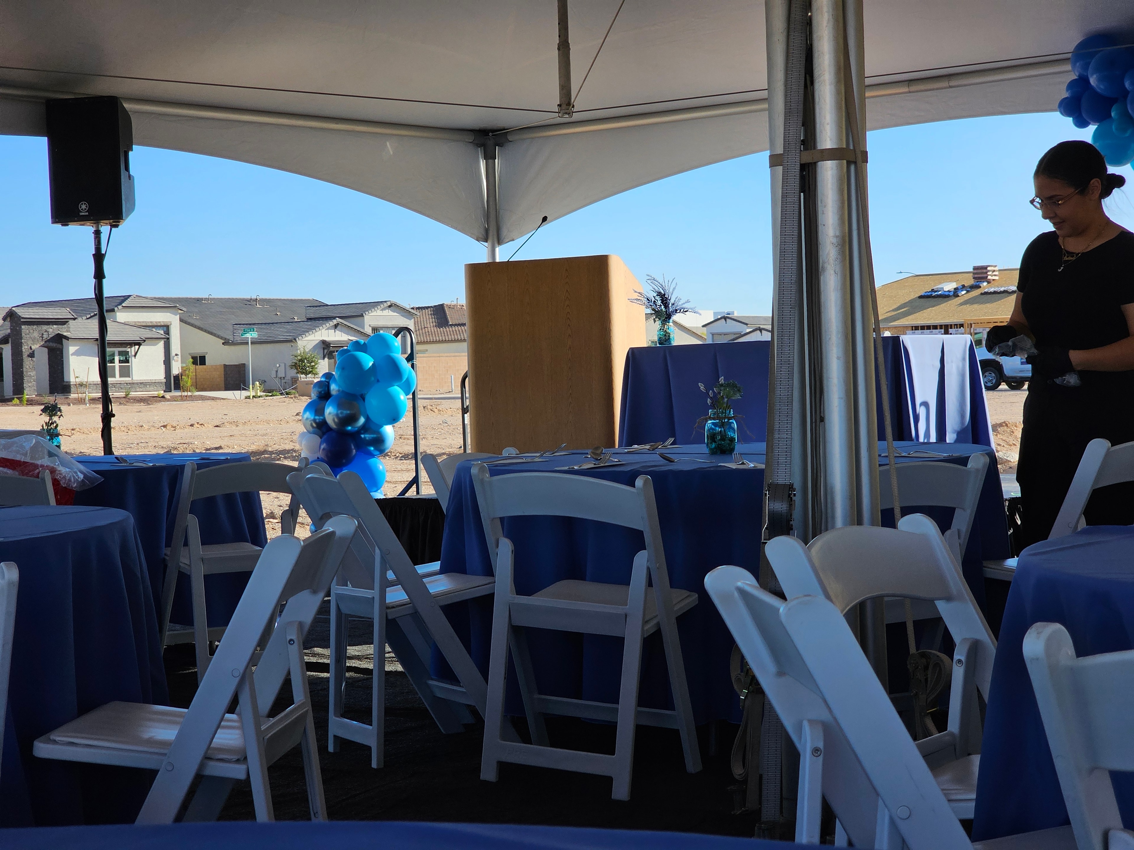 Outdoor event tent with blue decorations and tablecloths