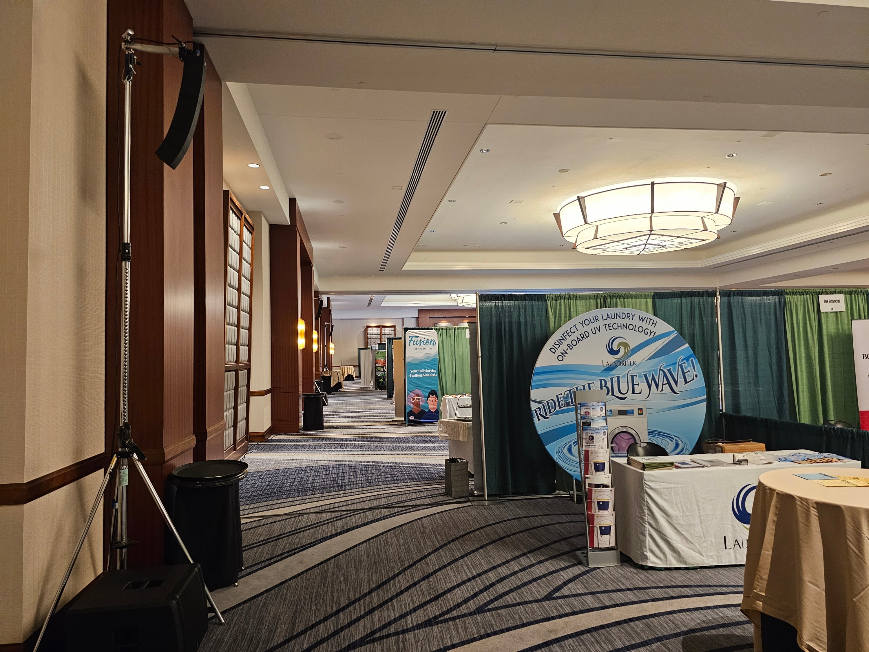 Trade show convention center hallway with vendor booths