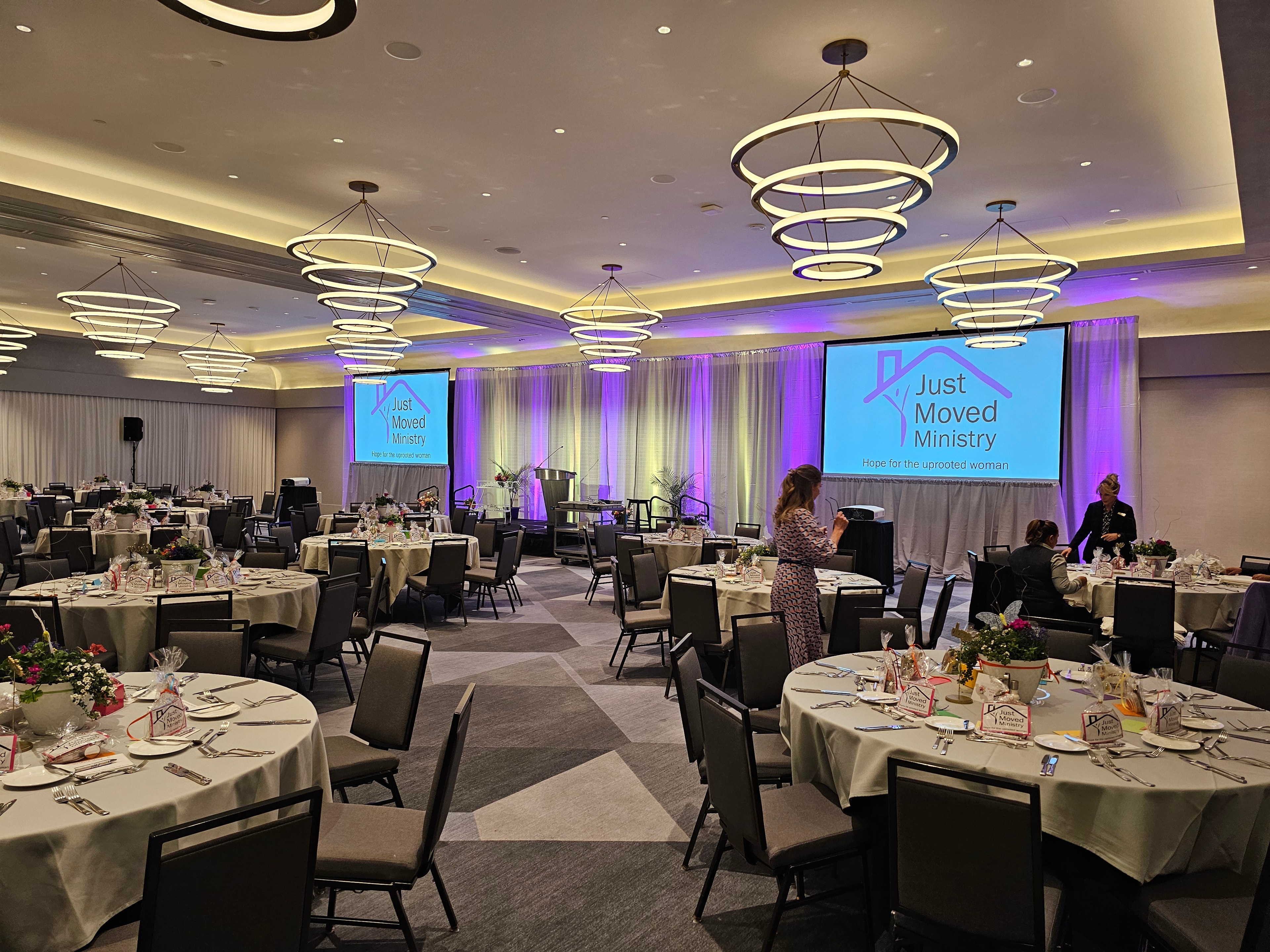 Elegant ballroom event with round tables and stage