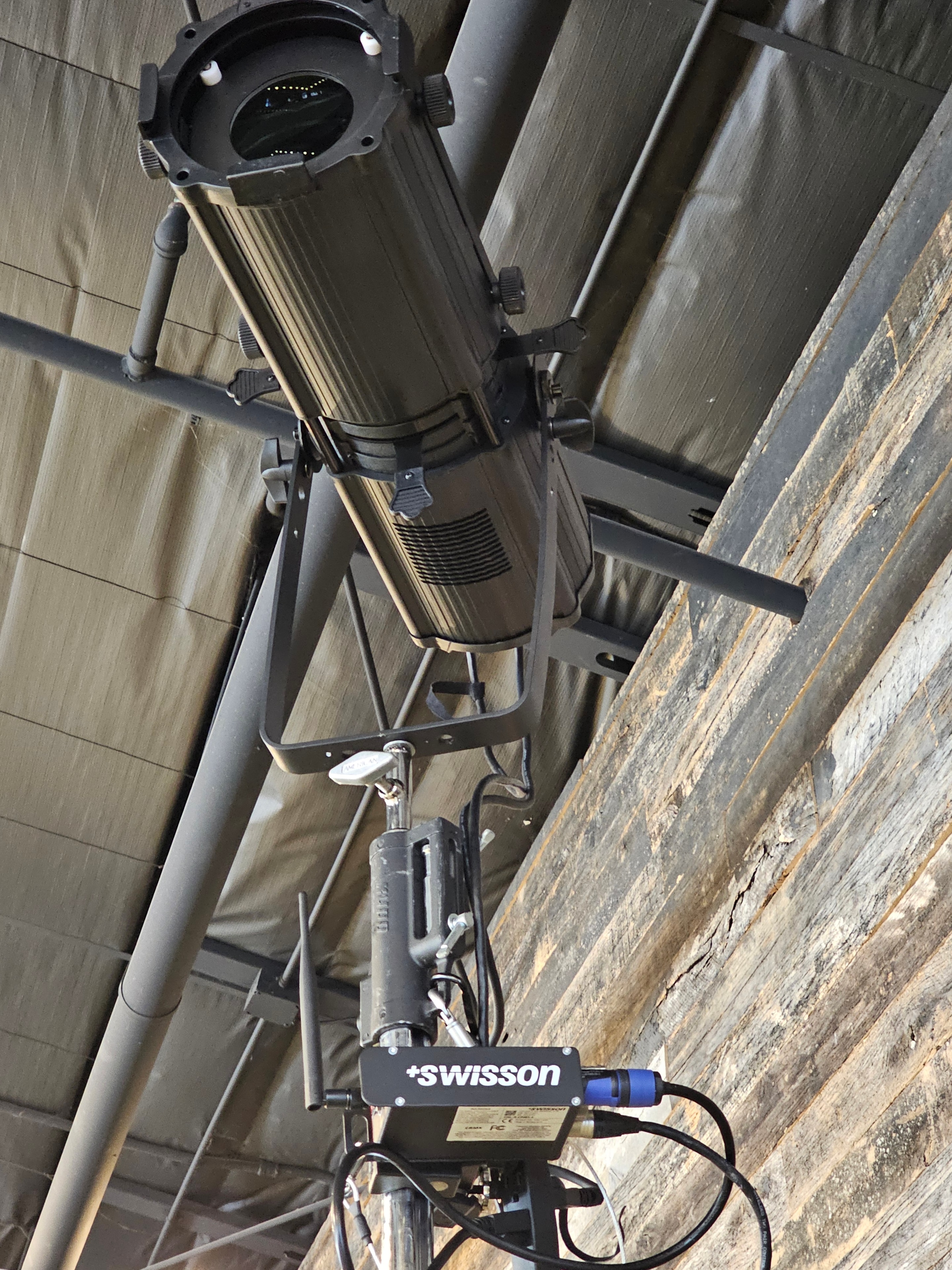 Professional stage lighting fixture mounted on pipe truss