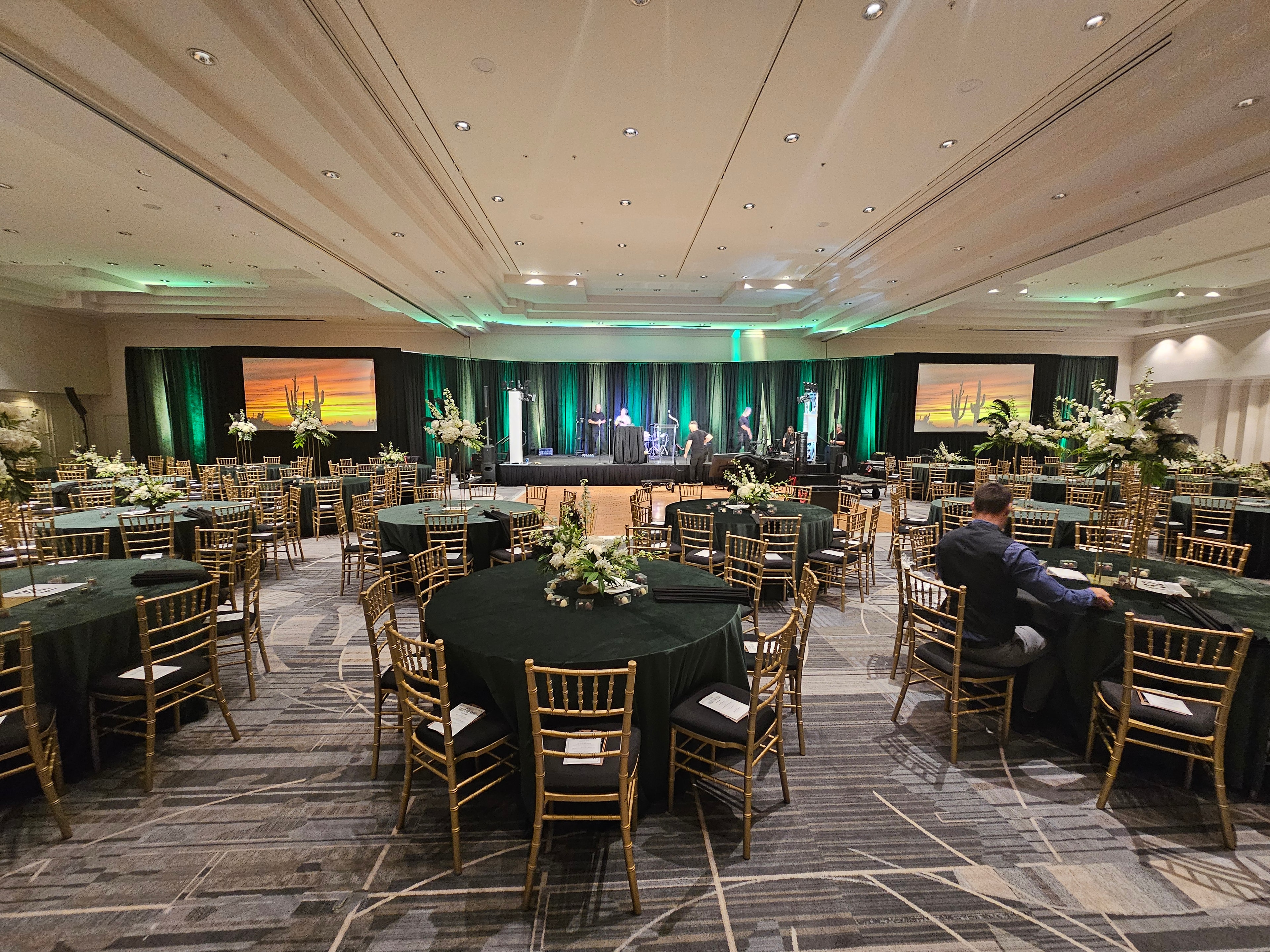Elegant ballroom with round tables and stage