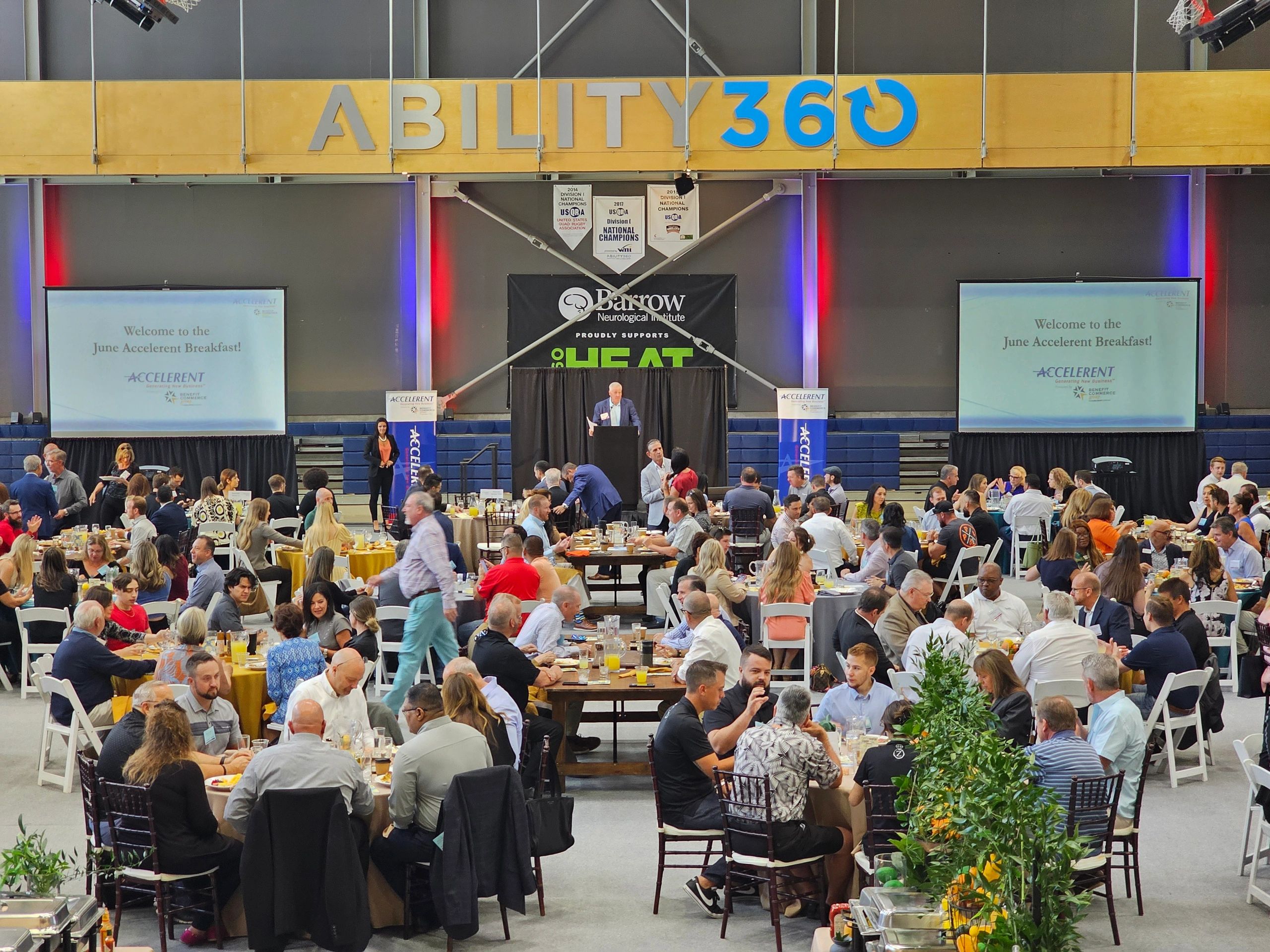 Large indoor event with stage and projection screens